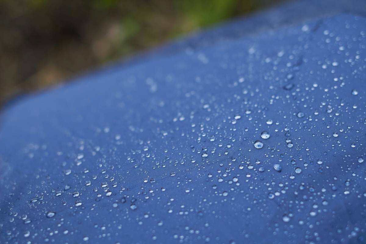 Bar chart comparing waterproof ratings and tear strength of 8 popular rain shield poncho covers, showing significant performance gaps by price tier