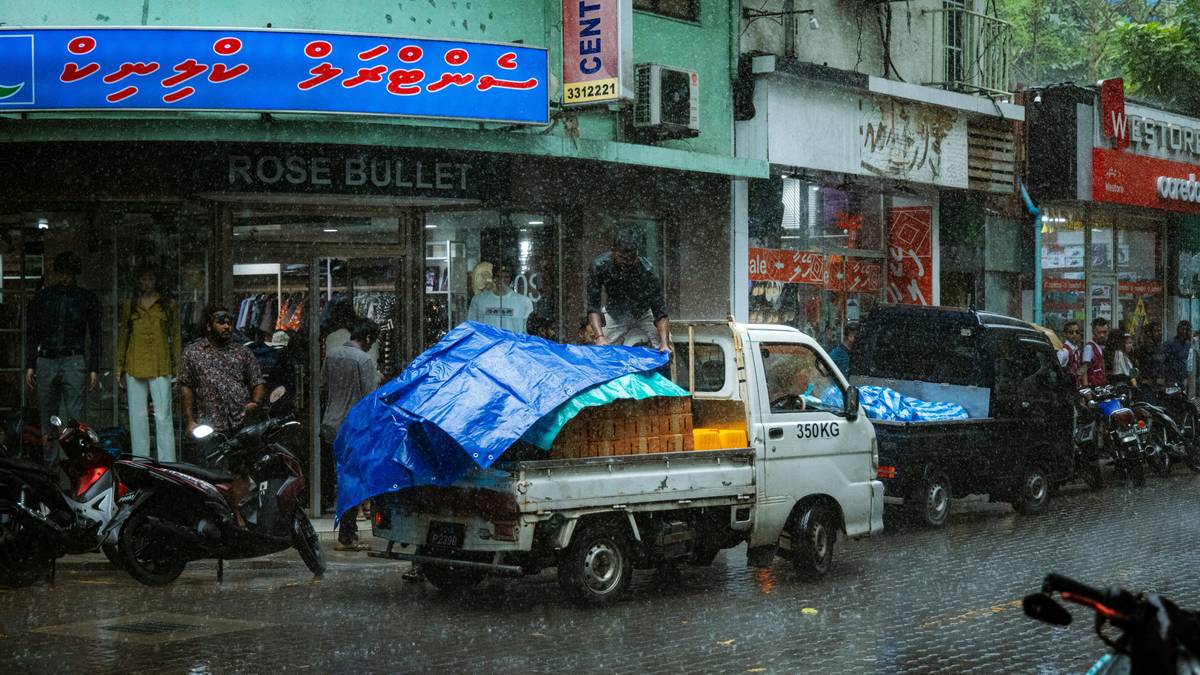 Backpacker wearing storm-defense poncho cover in heavy rain with full pack protection